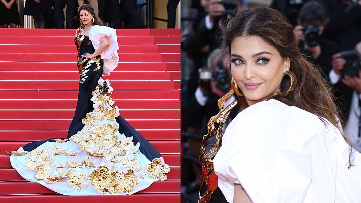 The attire featured a long trail with a chunky golden flower pattern